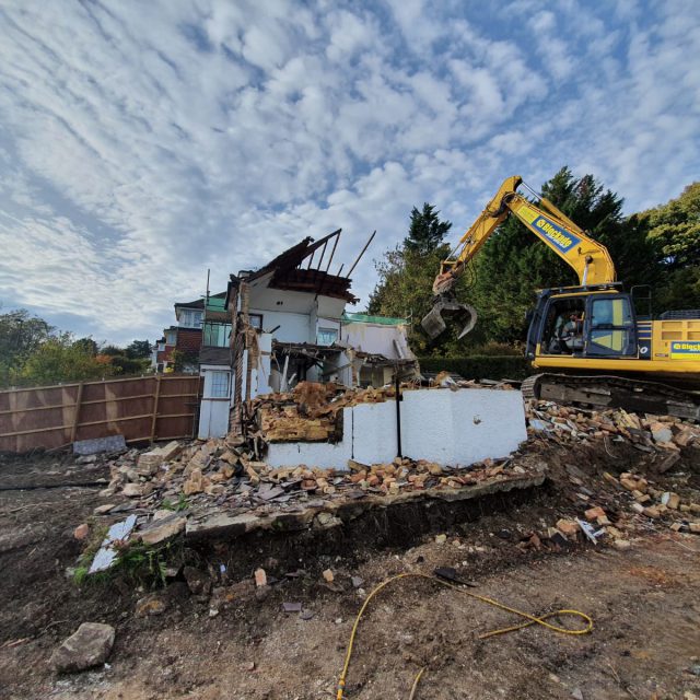 Blockade digger demolishing a house